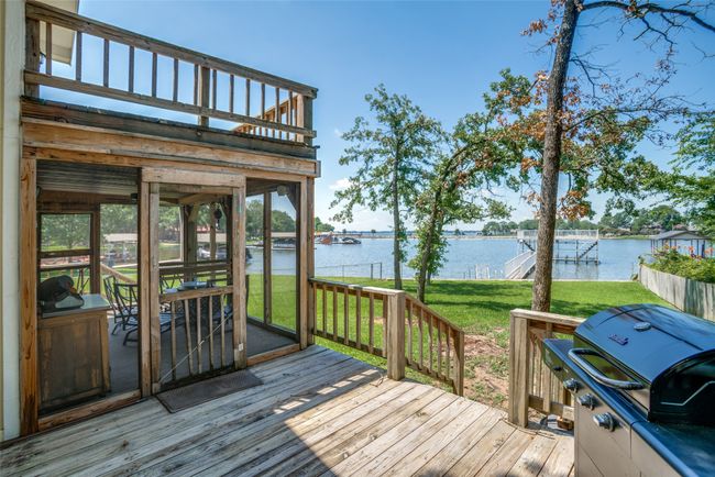 Deck with water view, a grill, and large back yard | Image 22