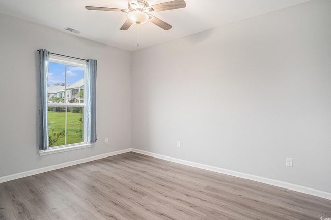Empty room featuring light wood-style floors and a ceiling fan | Image 23