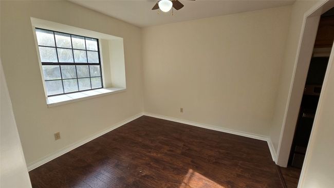 Empty room featuring a ceiling fan and dark wood-style flooring | Image 14