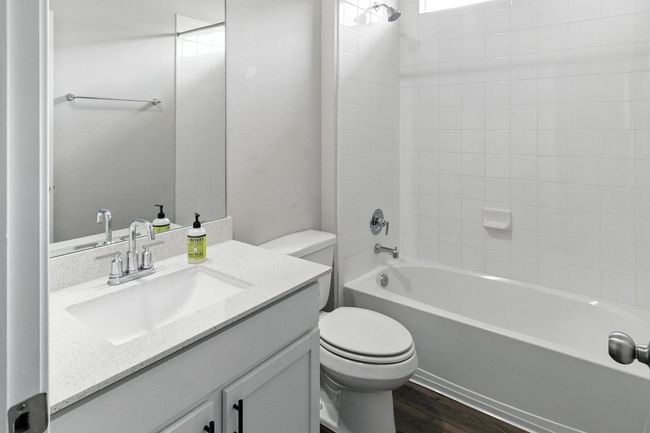 Full bathroom with vanity, bathing tub / shower combination, and wood finished floors | Image 20
