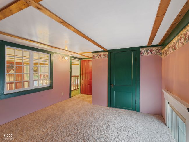 unfurnished room with carpet flooring and beam ceiling | Image 27