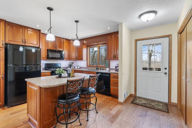 The foyer drops you into the beautifully updated kitchen. | Image 7