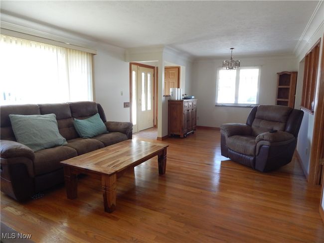Freshly Painted Living room featuring ornamental molding, and Gleaming Hardwood finished floors. | Image 5