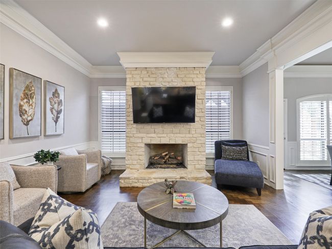 Living room featuring crown molding, a brick fireplace, wainscoting, and recessed lighting | Image 12
