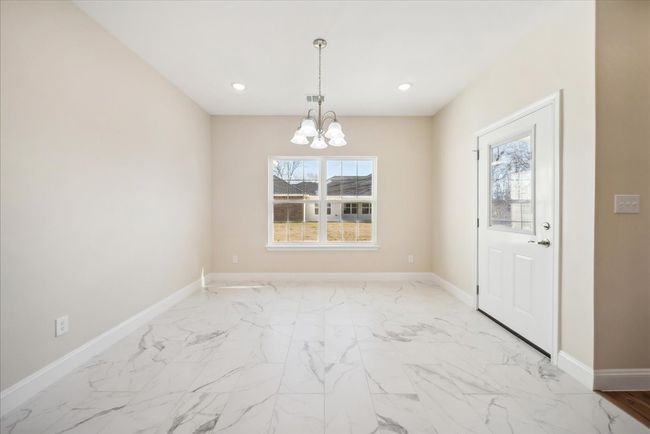 Unfurnished dining area featuring an inviting chandelier | Image 6