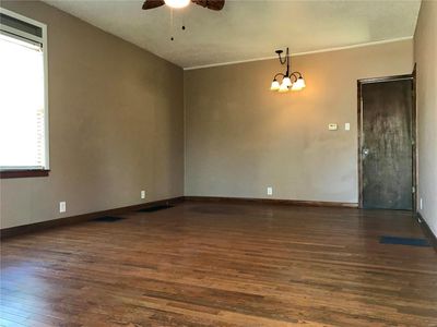 Living room featuring ornamental molding, dark wood flooring, and ceiling fan with notable chandelier | Image 3