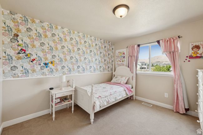 Bedroom with light carpet and baseboards | Image 23