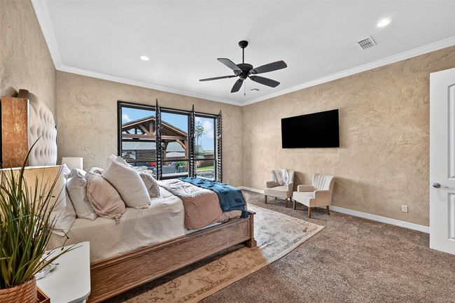 Carpeted bedroom with ornamental molding, ceiling fan, and recessed lighting | Image 21