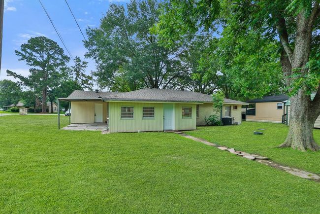 Backyard has access to the workshop. covered back patio. Beautiful large tree. Septic system helps keep taxes low. Large lot 19, 000+ | Image 25
