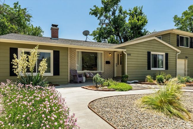 View of front of property featuring a chimney, covered porch, and brick siding | Image 8
