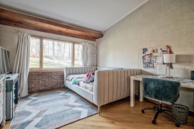 Bedroom with lofted ceiling and wood finished floors | Image 10