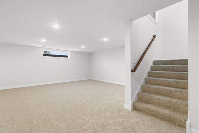 The FINISHED basement with an added window offers a spacious and versatile area perfect for a living room, game room, or kids' play area, providing endless opportunities for entertainment and relaxation. | Image 31
