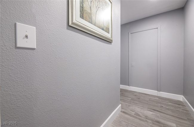 Corridor with baseboards and wood finished floors | Image 33
