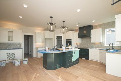 The kitchen in this home is a chef’s dream, featuring a large island with a veggie sink that provides ample prep space. | Image 2