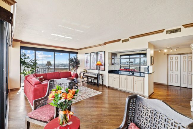 This angle showcases a bright and airy living space with an open floor plan. | Image 7