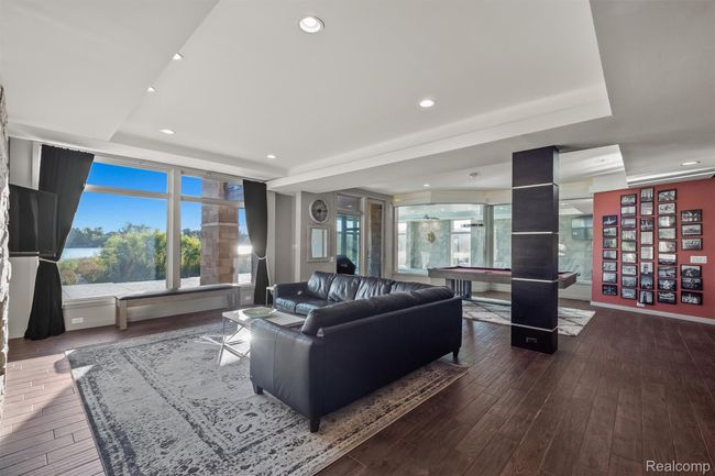 Living area with recessed lighting, plenty of natural light, dark wood-type flooring, and billiards | Image 25