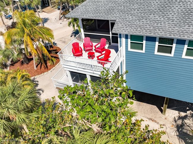 View of side of property featuring a shingled roof and stairway | Image 25