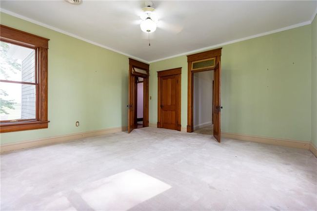 Unfurnished bedroom featuring crown molding, carpet floors, and ceiling fan | Image 26