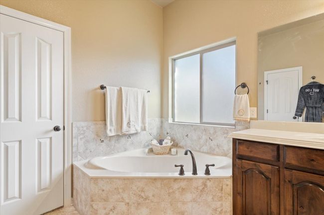 Full bathroom with vanity and a garden tub | Image 24