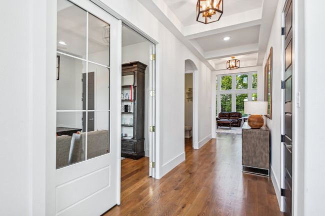 Entrance foyer with a chandelier, arched walkways, dark wood-style floors, and recessed lighting | Image 7