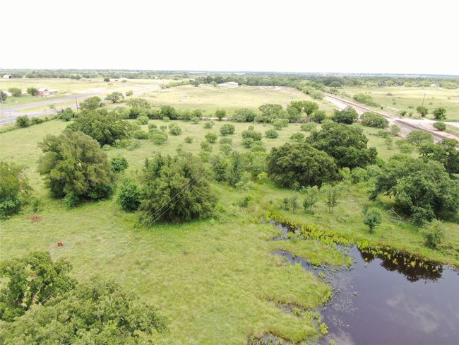 Aerial view of sparsely populated area with a large body of water | Image 29