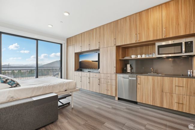 Living room with recessed lighting, wet bar, and light wood-type flooring | Image 17