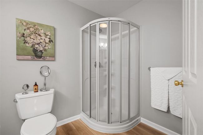 White cabinets, granite countertops and the vinyl plank flooring are the perks to this master bathroom. | Image 25