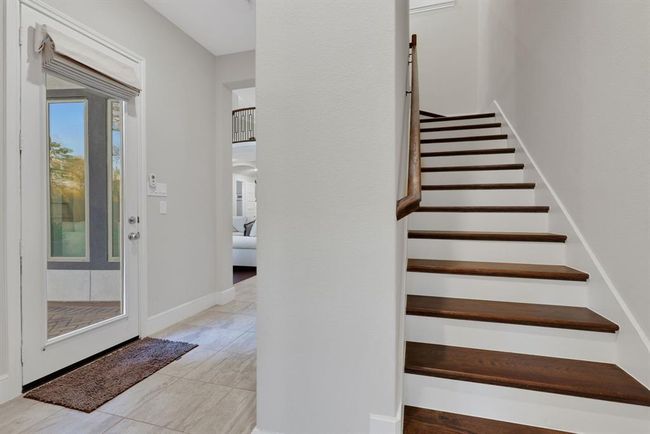 Back staircase to allow easy access to the second story. Located just inside from the three-car tandem garage. | Image 34
