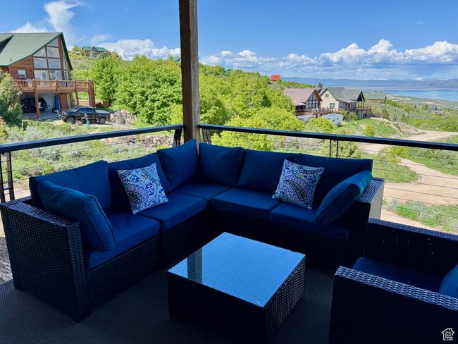 Deck with an outdoor living space and lake view and new outdoor furniture | Image 25