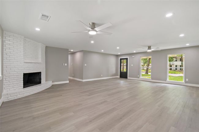 1st view of living/family area overlooking front yard. Nice large windows on both sides to allow natural light into the home. | Image 18