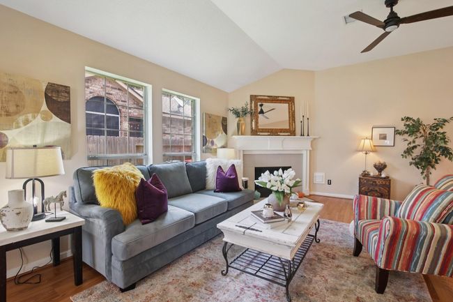 Bright, inviting living room with high ceilings and hardwood floors. | Image 8