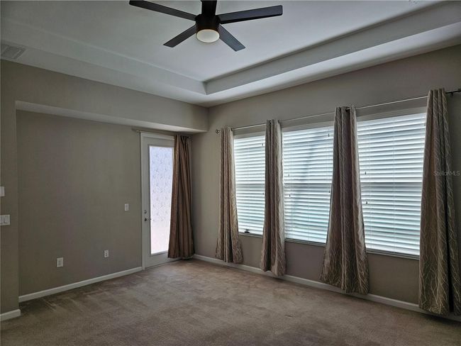 Downstairs primary suite with separate access to screened lanai. | Image 18