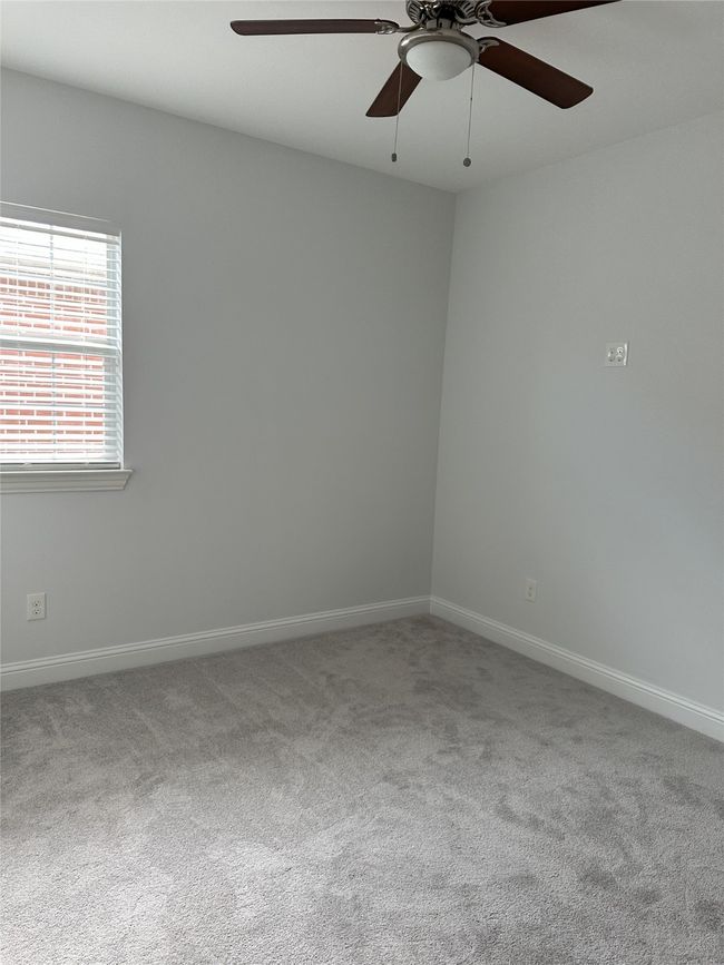 Carpeted spare room featuring a ceiling fan | Image 12