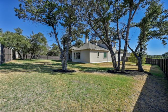The well-maintained lawn and mature landscaping add to the home's curb appeal. | Image 26