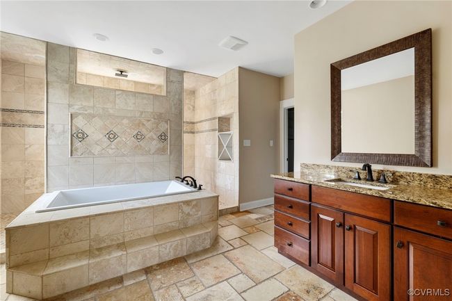 Full bath featuring stone tile floors and vanity | Image 32