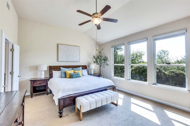 Large primary suite with multiple windows for natural light and greenbelt view | Image 13