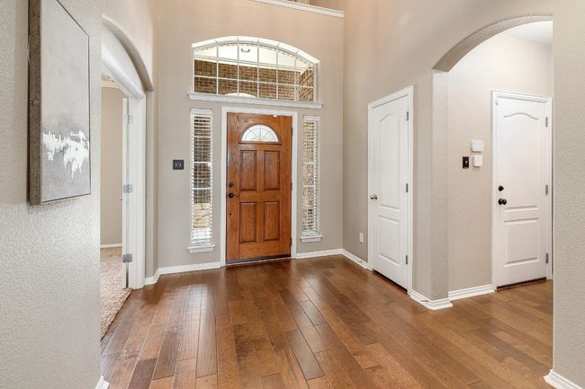 As you walk through the front door, you're immediately greeted by a sense of openness, with soaring ceilings and a clear view into the inviting living space, setting the tone for the rest of the home’s layout | Image 8