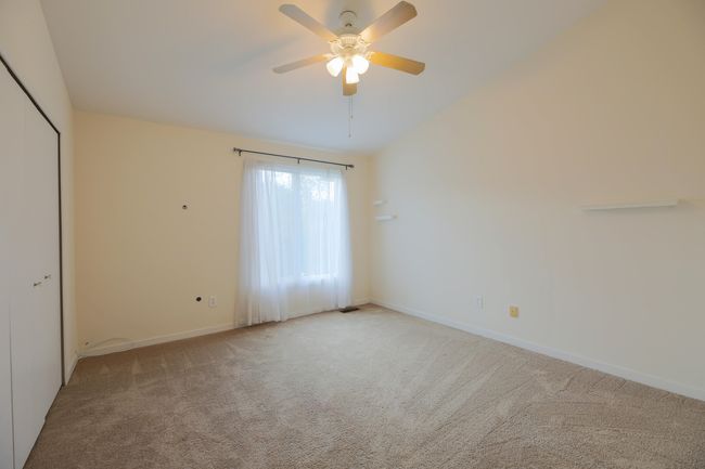 Another view of the second bedroom filled with natural light and large closet. | Image 16