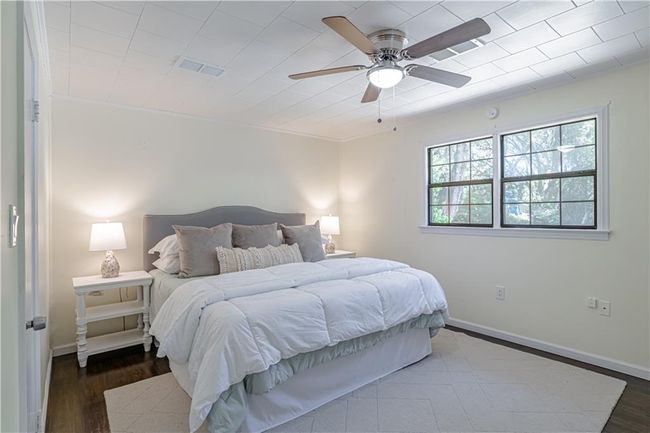 Bedroom featuring dark hardwood / wood-style flooring and ceiling fan | Image 32