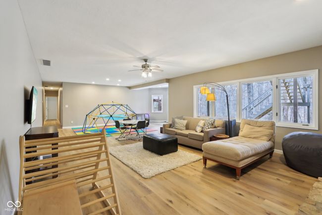 living room featuring baseboards, visible vents, ceiling fan, and light wood-style flooring | Image 42