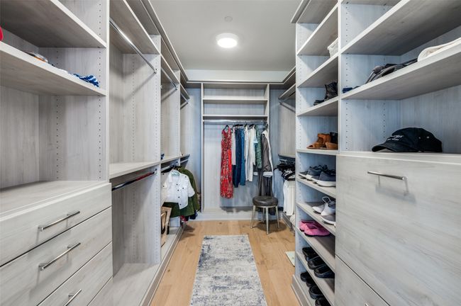 Walk in closet featuring light wood-style floors | Image 22