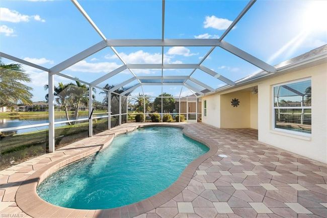 Pool with a patio area and a water view | Image 29