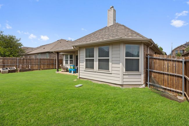 Back of property with a shingled roof, a fenced backyard, a chimney, and a yard | Image 29