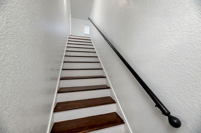 Stairs featuring a textured wall | Image 18