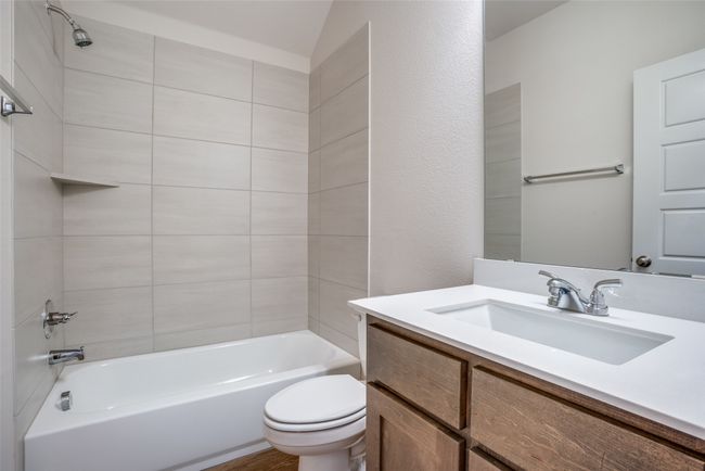 Bathroom with vanity, toilet, and shower combination | Image 21