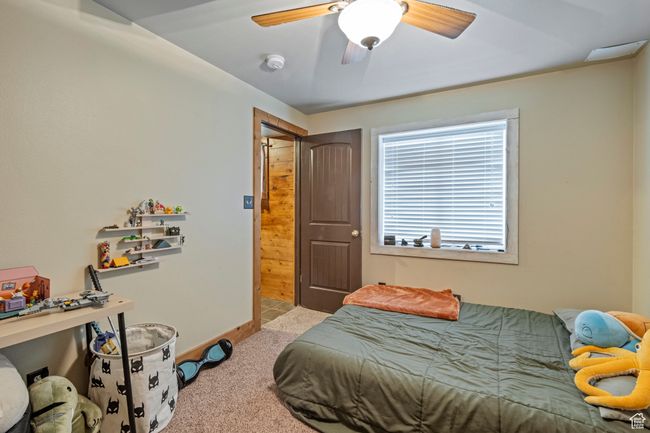 Carpeted bedroom with ceiling fan | Image 27