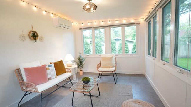 The fully conditioned four season porch is filled with natural light and is suitable for year round use thanks to the newly installed mini-split system. | Image 41