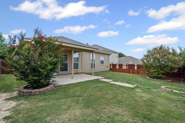 Rear view of property featuring a fenced backyard and a patio | Image 31