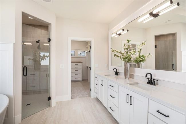 Bathroom with double vanity and a stall shower | Image 18