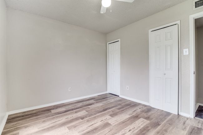 Unfurnished bedroom featuring light wood finished floors and a ceiling fan | Image 16